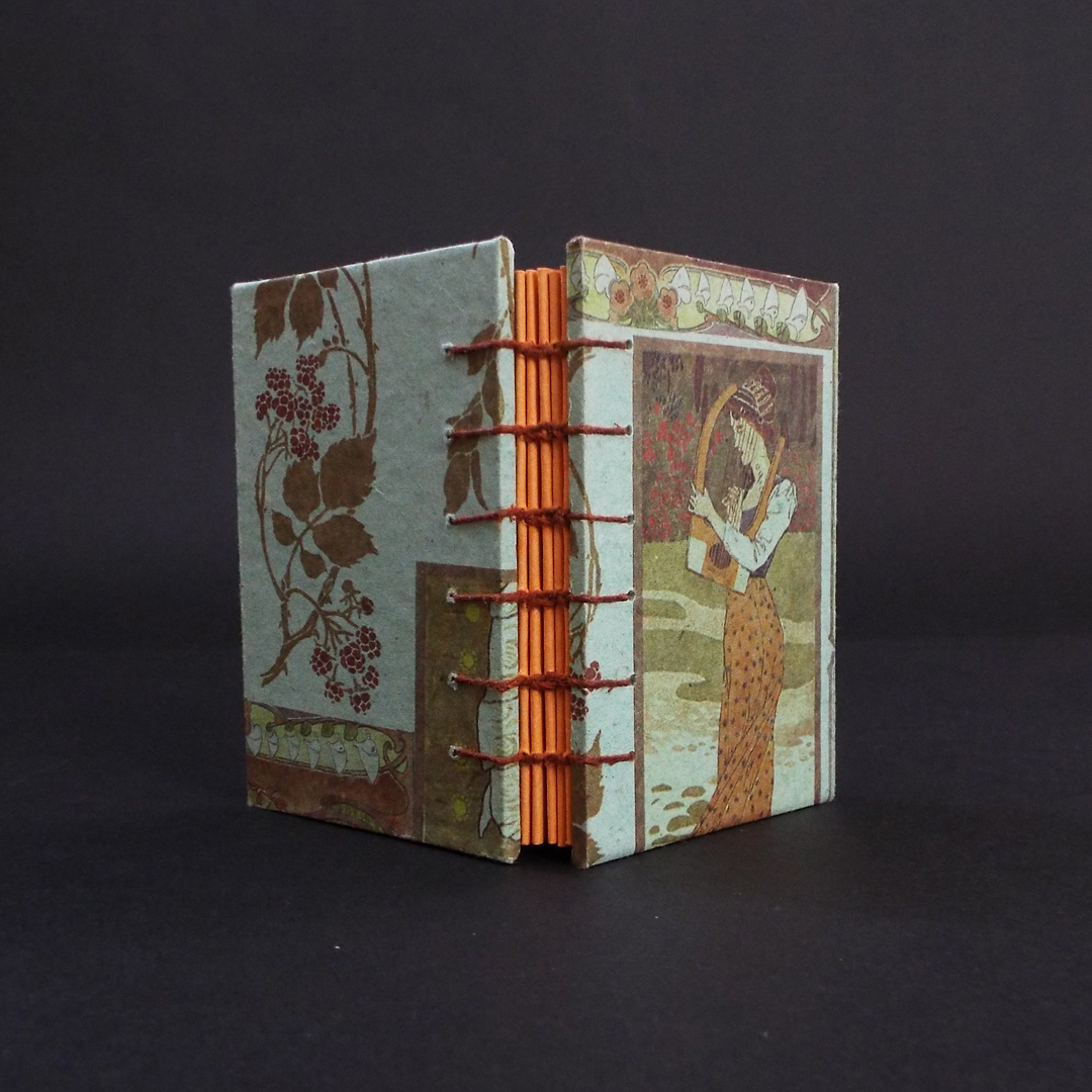 Art Nouveau Lady Coptic bound journal spine showing the stiching