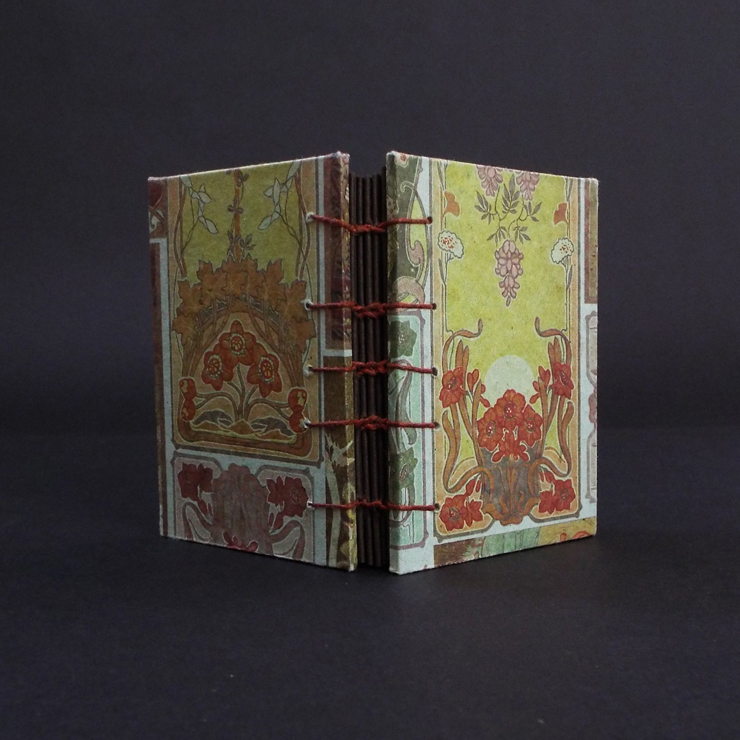 Art nouveau floral coptic bound journal spine showing the stitching