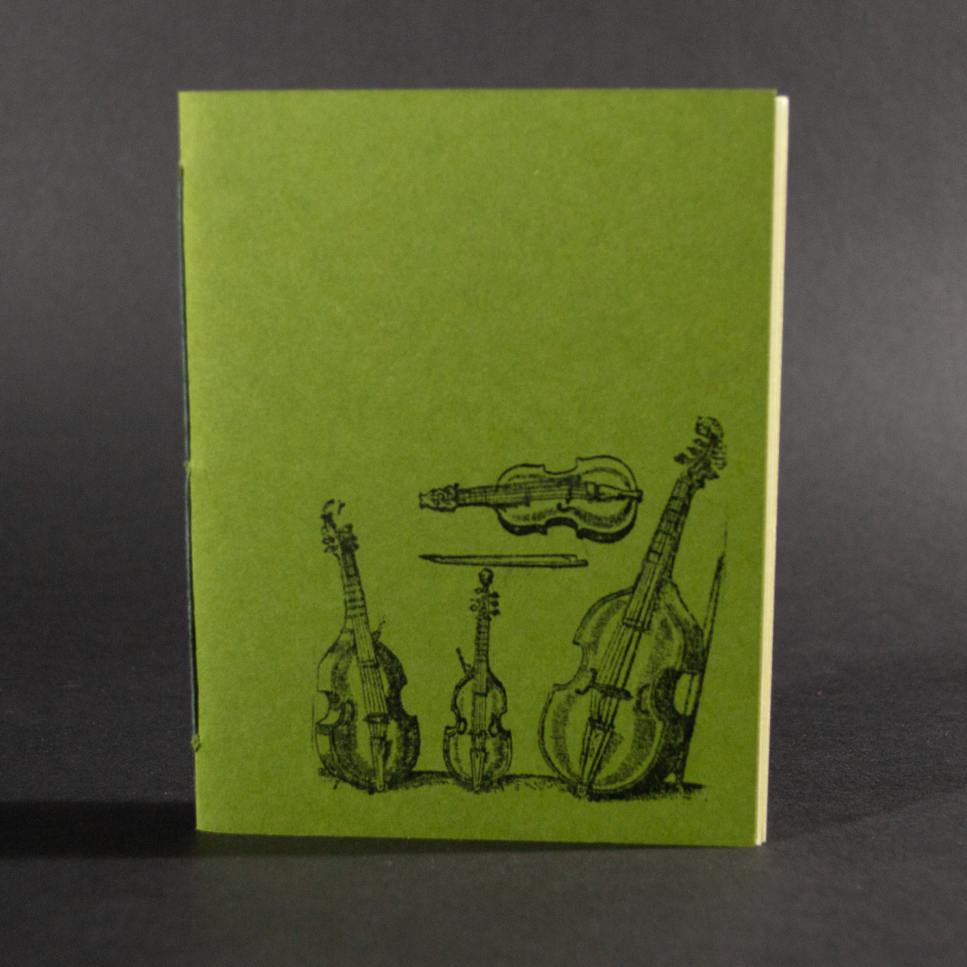 Four stringed instruments are on the cover of this green octavo pamphlet book