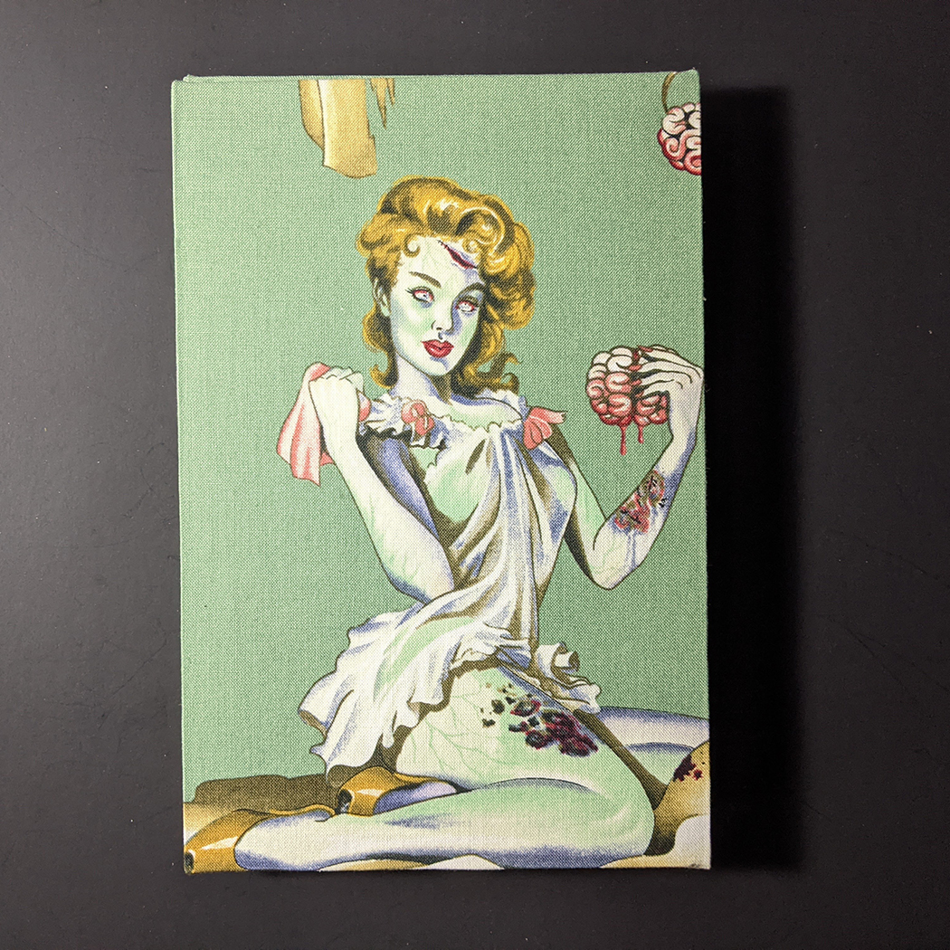 The back cover of retro circles quarto Coptic bound journal has a pine up zombie girl on a green background
