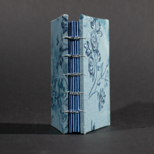 Spine view of vintage blue floral mini Coptic book