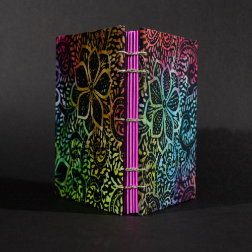 Spine view of rainbow batik flowers octavo Coptic book