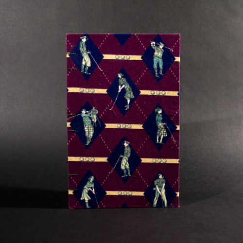 Front cover of retro golfers quarto Coptic bound journal with images of golfers on a burgundy background.