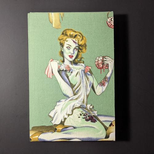 The back cover of retro circles quarto Coptic bound journal has a pine up zombie girl on a green background