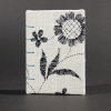 Front cover of lack and white floral mini Coptic book