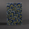 The front cover of the peacock medium accordion book has peacock feathers in blue and gold.